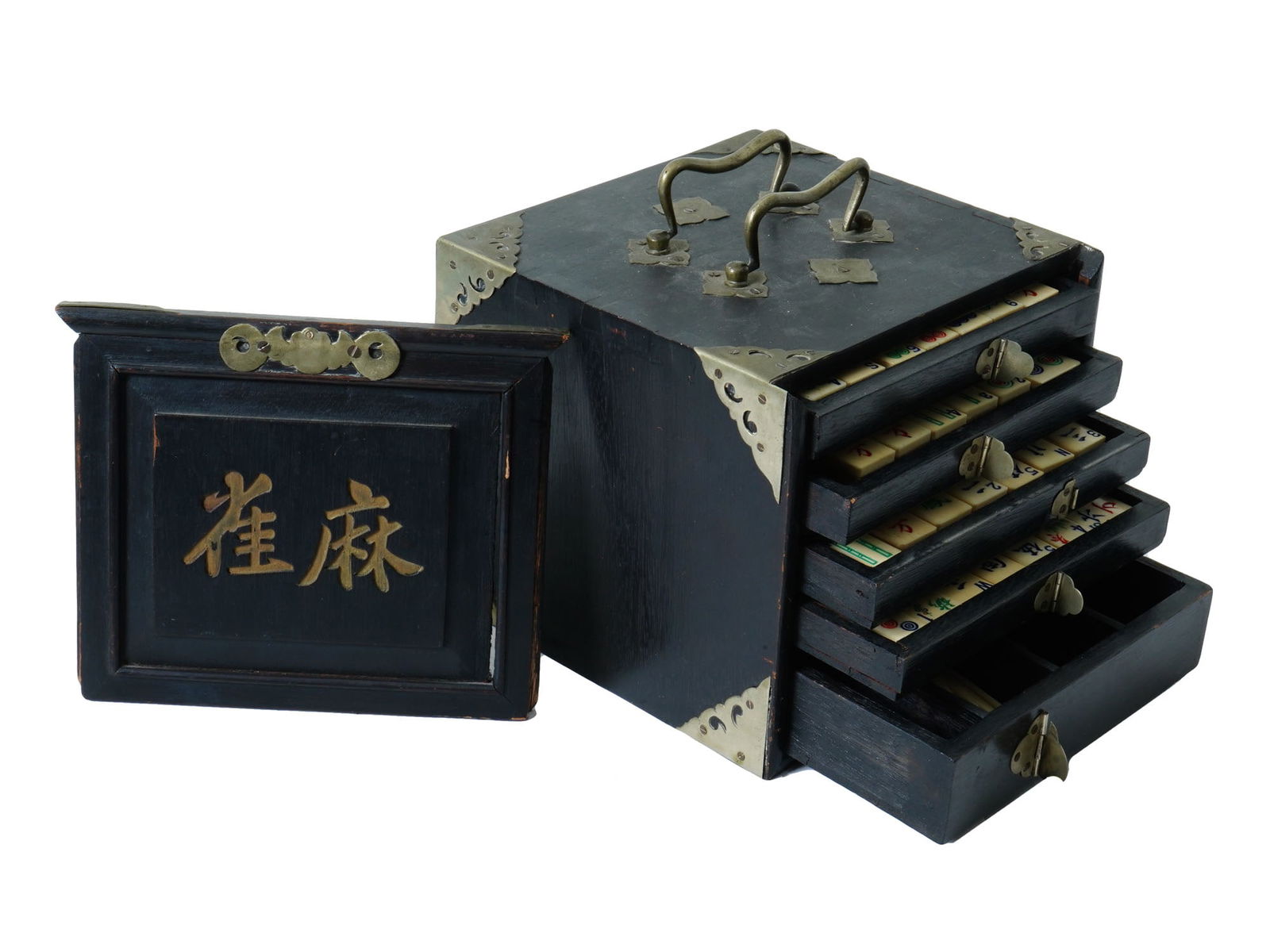 ANTIQUE CHINESE MAHJONG GAME SET IN HARDWOOD CASE: An antique Chinese mahjong game set. The game is stored in a hardwood case with a dark stain and decorative brass corner pieces with brass handles. The case has multiple drawers, revealing the bone an