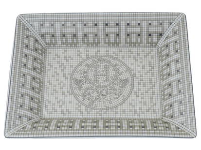 VINTAGE HERMES MOSAIQUE AU 24 PORCELAIN ASHTRAY: A vintage porcelain mosaic ashtray by Hermes. Rectangular piece with transfer printed Mosaique au 24 Platinum decoration. Tiny grey tiles, create graphic motifs at the crossroads of Art Deco and ancie