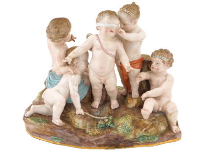 ANTIQUE GERMAN MEISSEN PORCELAIN SCULPTURAL GROUP: An antique German Meissen hand painted polychrome porcelain sculptural group. The item depicts a scene with a group of putti playing hide and seek. Marked with a blue crossed swords mark and numbered