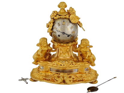 ANTIQUE 19TH C FRENCH GILT BRONZE MANTEL CLOCK: An antique Louis XVI style French gilt bronze mantel clock with key-wind mechanism, Paris, late 19th century. Features a silver plated globe dial with applied Roman gilt bronze numerals. Surmounted wi