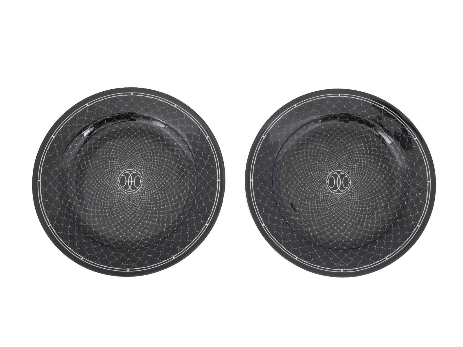 VINTAGE HERMES H DECO BLACK DESSERT PLATES: A pair of vintage porcelain dinner plates by Hermes. H Deco collection. Screen-printed black and white ornament. Hallmarked on the bottom. Inspired by the Art Deco ironwork of Hermes Parisian stores,