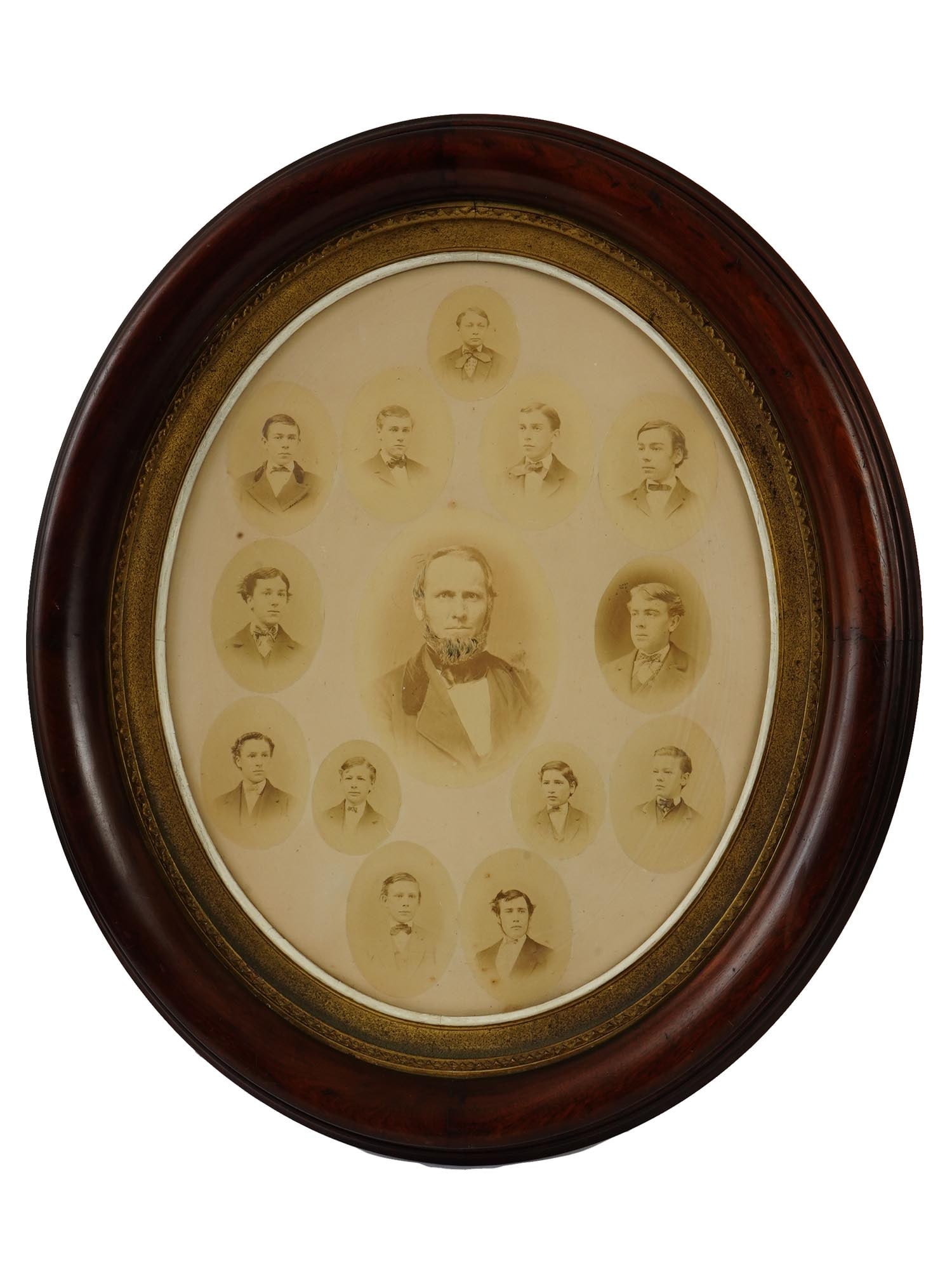 ANTIQUE AMERICAN FAMILY PHOTOGRAPH MALE PORTRAITS FRAMED: An antique American family photograph of male members, arranged with a larger central oval portrait surrounded by smaller individual portraits, capturing multiple generations. Housed in its oval woode