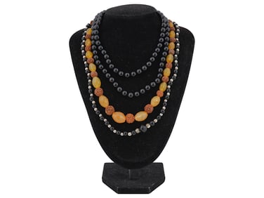 COLLECTION OF NECKLACES WITH CARVED STONE BEADS