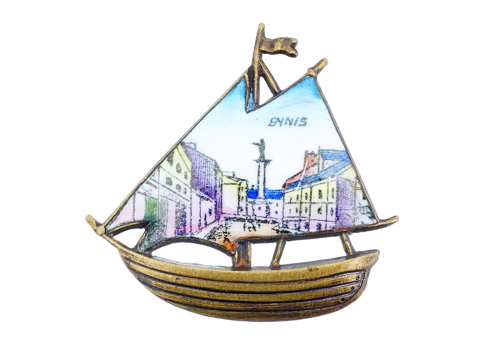 VINTAGE CZECH ENAMELED BRASS SHIP BROOCH: A vintage brass pin brooch representing a sailing ship. Enameled sail depicts a hand-painted cityscape titled Ennis. Hallmarked Czechoslovakia on the backside. Ennis is a town in Texas, US with a larg