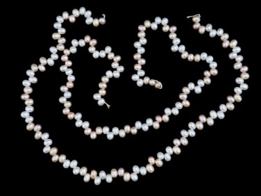 TWO STRINGS OF NATURAL TEAR DROP SHAPED PEARL BEADS