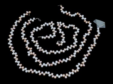 THREE STRINGS OF NATURAL OVAL SHAPED PEARL BEADS
