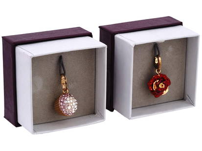 NEW GOLD PLATED ST SILVER CHARMS BY JUDITH LEIBER: A lot of two brand new gold plated sterling silver Cupcake and Red Rose shaped charm pendants by Judith Leiber Jewelry. The top of the items is garnished with pink and red cubic zirconia stones. Marke