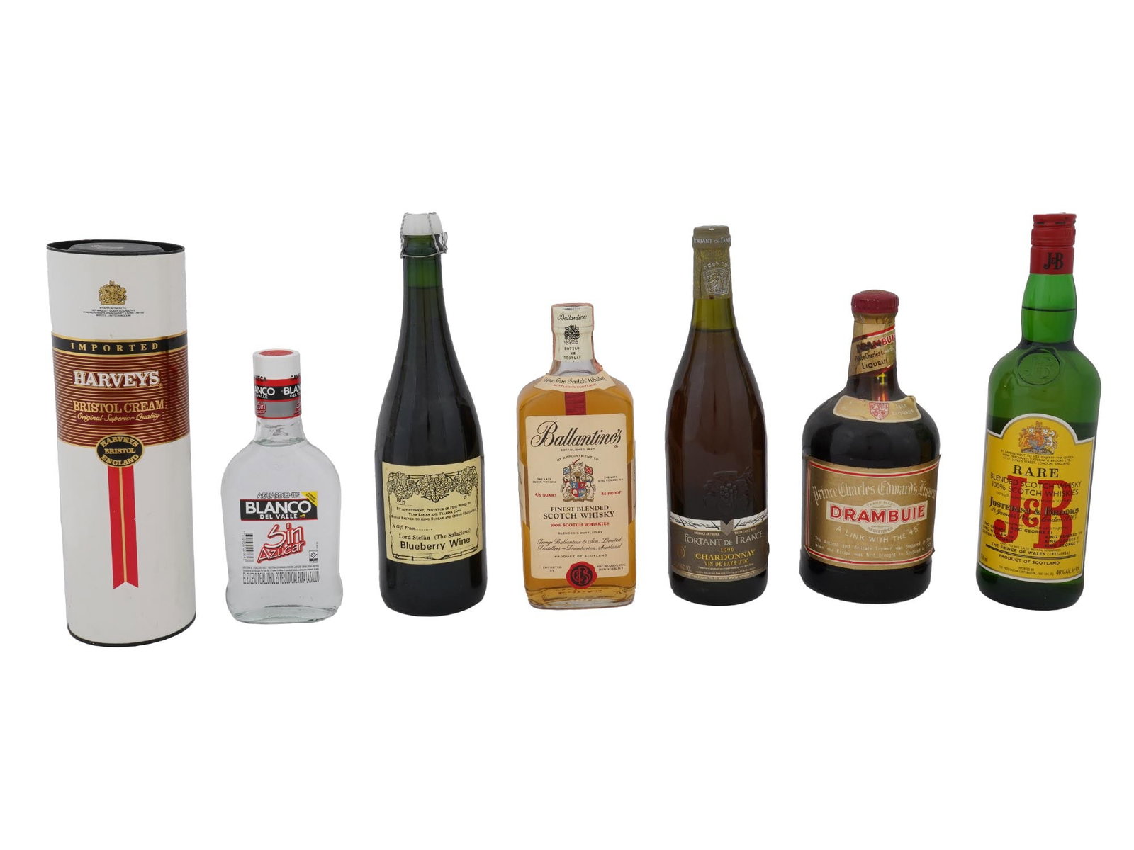 VTG BOTTLES OF ALCOHOLIC DRINKS FROM RENOWNED BRANDS: A collection of vintage bottles of alcoholic beverages from renowned brands, offering a diverse selection of liqueurs, wines, and spirits, including Harveys Bristol Cream, Blanco del Valle, Blueberry 