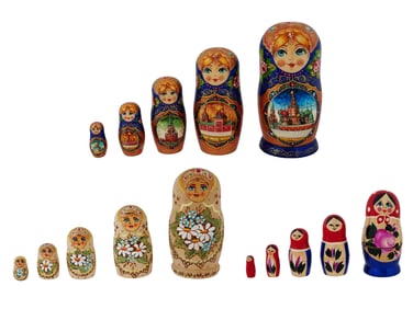 THREE RUSSIAN TURNED WOOD AND PAINTED NESTING DOLL SETS