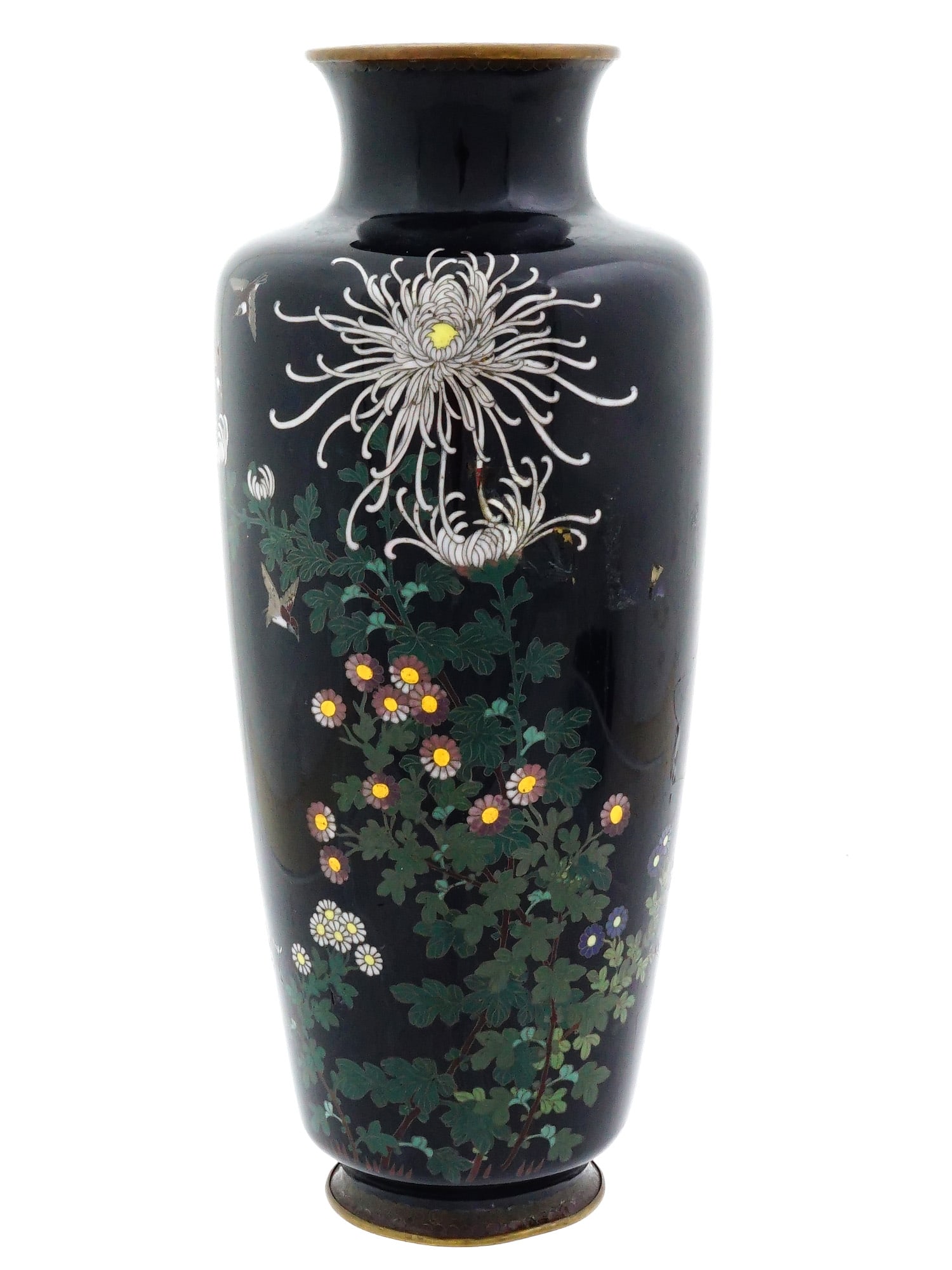 JAPANESE FLOWERS CLOISONNE ENAMEL OVER COPPER VASE: A Japanese enamel over copper vase. The vase has an urn shaped body and a wide neck with a fluted mouth. The vase is enameled with a polychrome design representing blossoming flowers made in the Clois