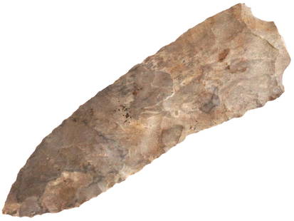 ANCIENT NATIVE AMERICAN INDIAN BENTON STONE ARROWHEAD: An ancient Native American Indian Benton area handcrafted stone arrowhead. The spearhead is elongated, light brown in color, with a pointed end and serrated edges. Such items always had a pointed end