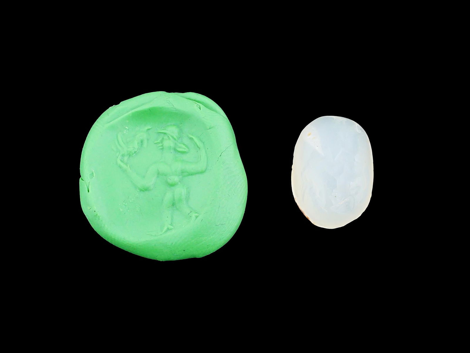 CARVED STONE INTAGLIO ANCIENT ROMAN MALE FIGURE ROOSTER: A carved stone intaglio featuring an ancient Roman image of a male figure, with a rooster on his hand. Such intaglios were used as personal seals, amulets, or decorative jewelry, showcasing the Romans