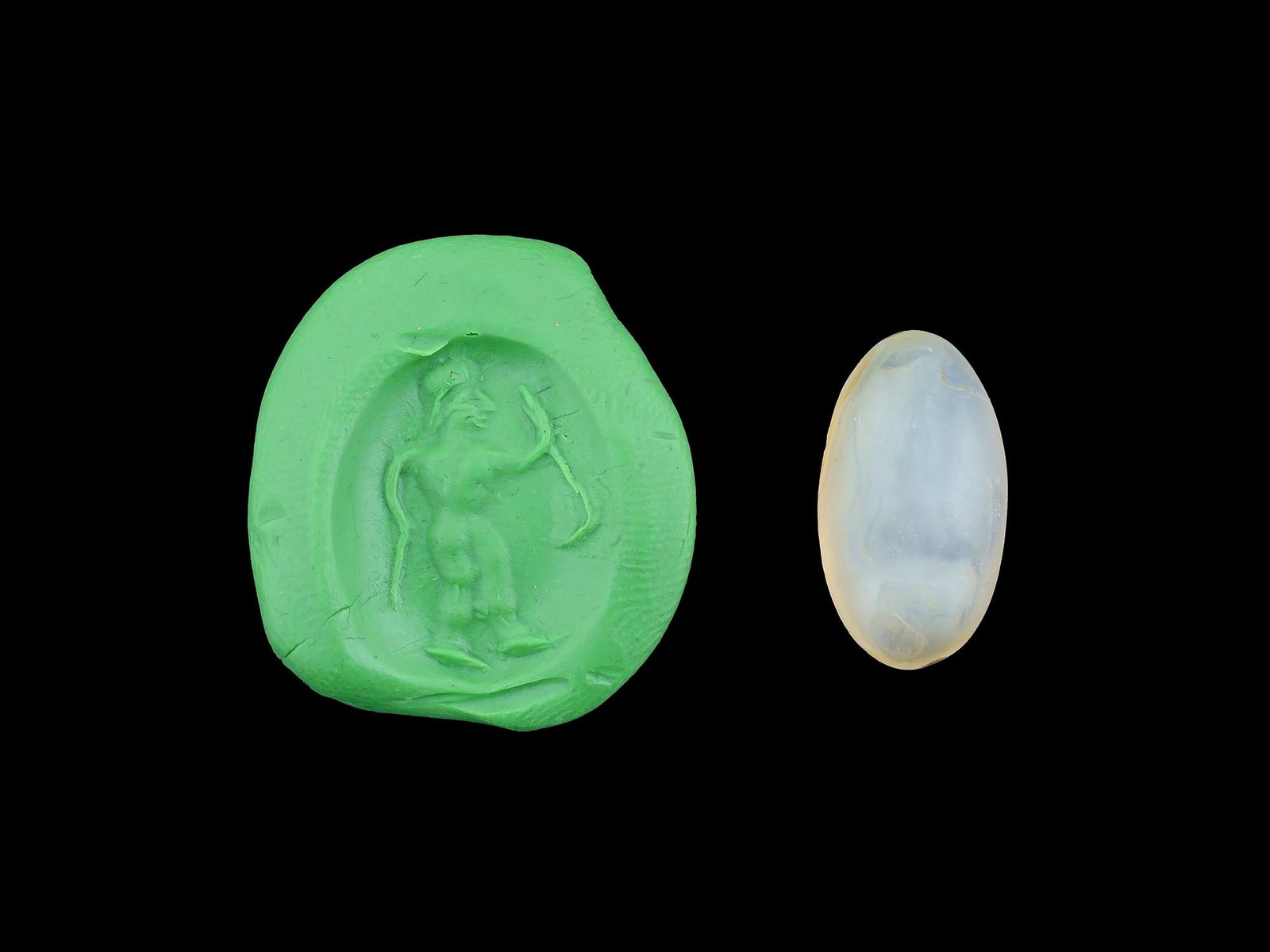 CARVED STONE INTAGLIO ANCIENT ROMAN HUMAN FIGURE: A carved stone intaglio featuring an ancient Roman depiction of a human figure. Such intaglios were used as personal seals, amulets, or decorative jewelry, showcasing the Romans appreciation for mytho