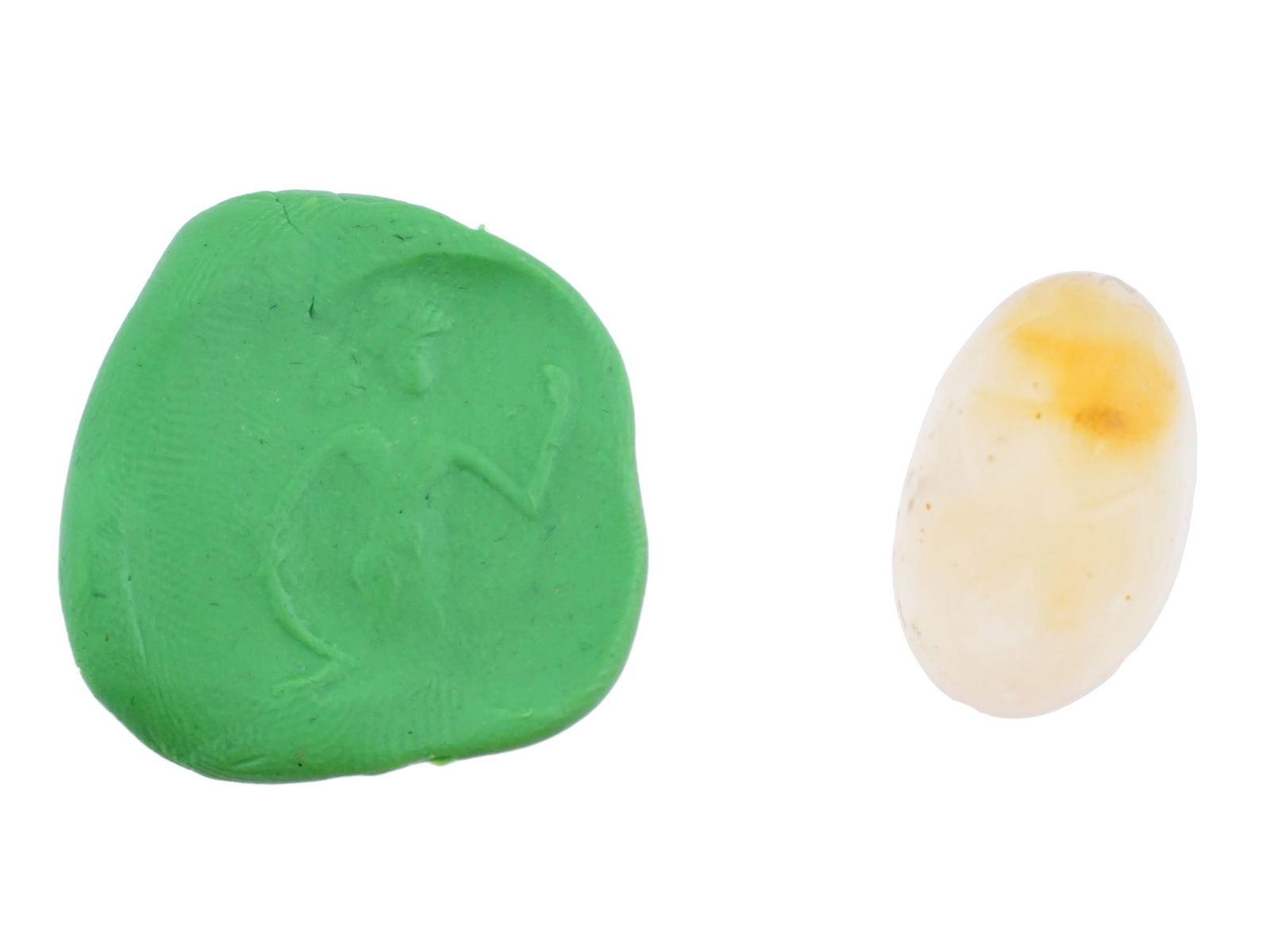 CARVED AGATE INTAGLIO WITH ANCIENT ROMAN EROTIC SCENE: A carved agate intaglio featuring a detailed depiction of the ancient Roman erotic scene from classical mythology. Such pieces were often used as personal seals, amulets, or jewelry. Roman Carvings An