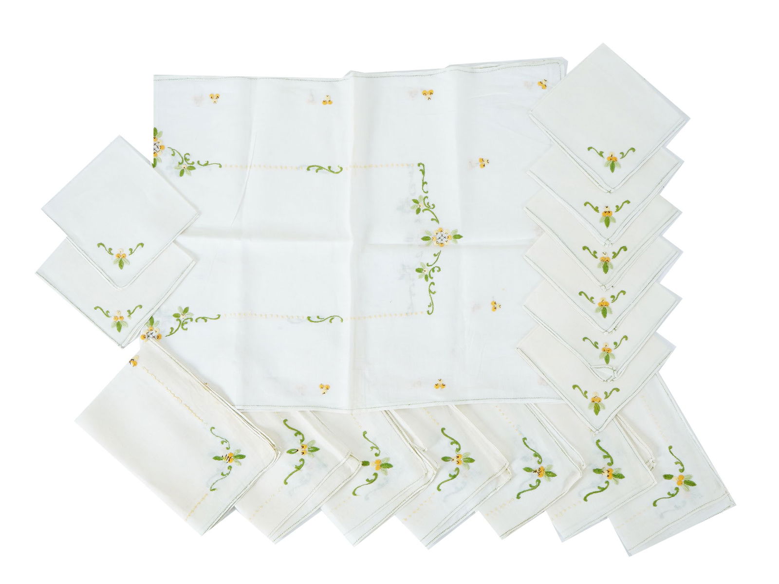 VINTAGE HAND EMBROIDERED W FLORAL DESIGN LINENS: A set of vintage hand embroidered linens all adorned with delicate floral and foliate designs in green and yellow thread. The fabric and meticulous embroidery highlight the craftsmanship and decorativ