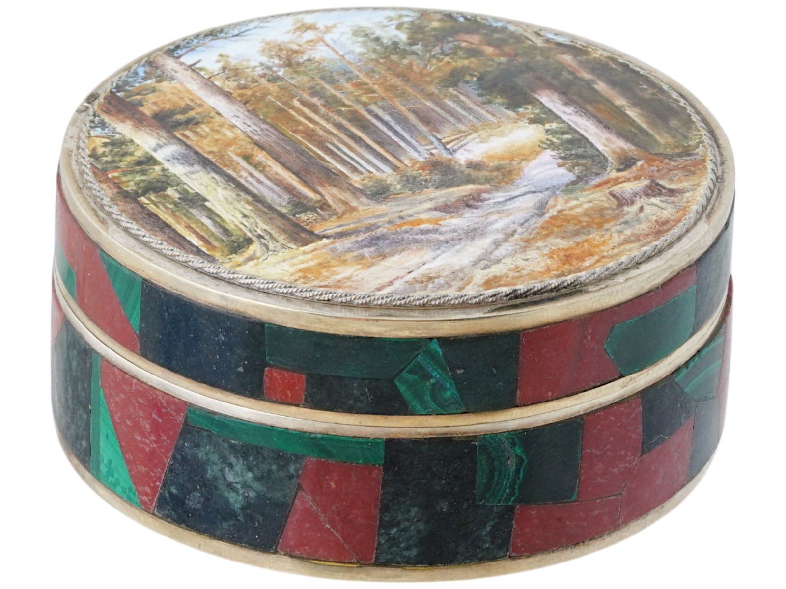 RUSSIAN SILVER MOSAIC BOX W MINIATURE ENAMEL PAINTING: A Russian silver pill box of a round form, the matched lid is decorated with a fine enamel miniature painting depicting a forest landscape after Ivan Shishkin. The exterior of the box is adorned with
