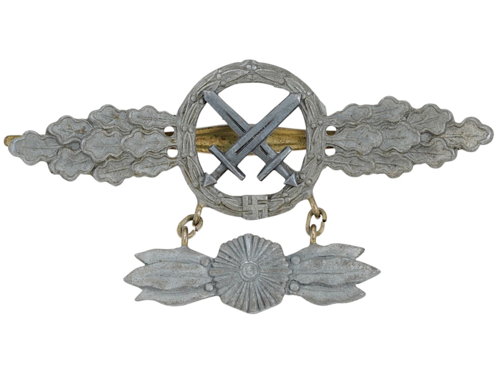 WWII NAZI GERMAN LUFTWAFFE ATTACK AIRCRAFT BADGE: A World War II Nazi German Luftwaffe attack aircraft badge. It features crossed swords in the center and wings with oak leaves. It has an additional pendant in the form of an eight pointed star framed