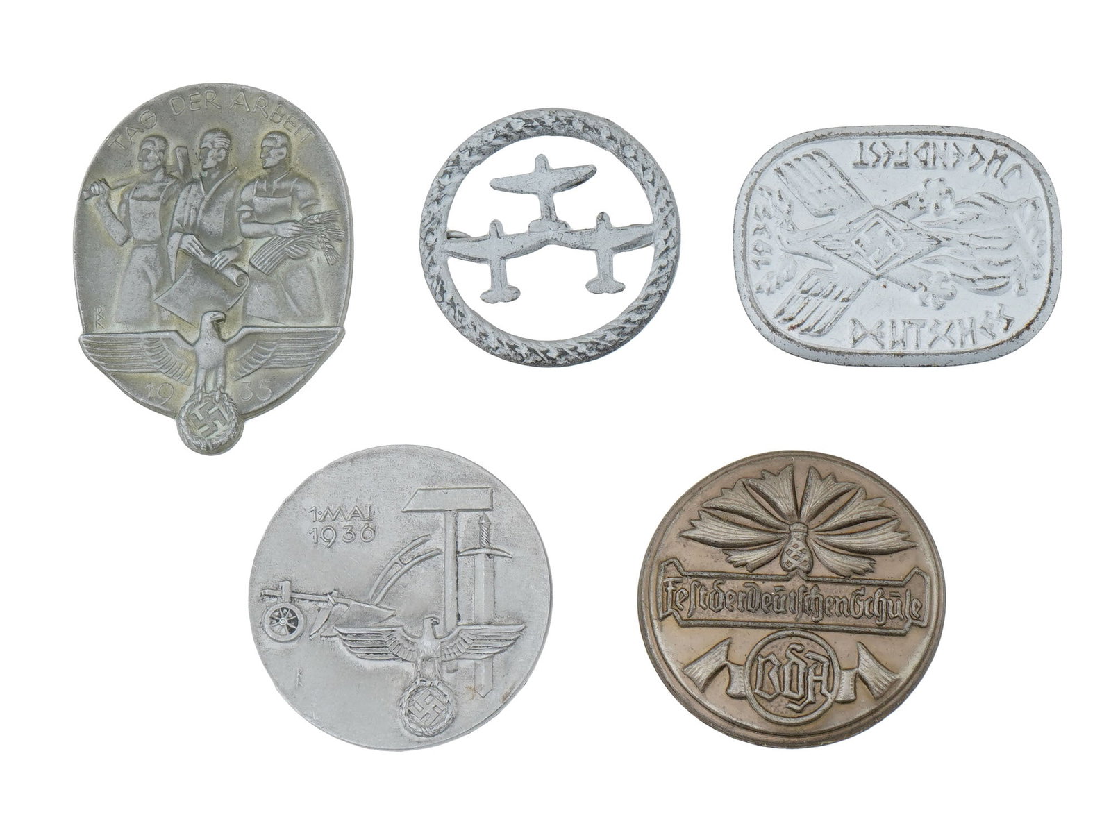 PRE WWII NAZI GERMAN THIRD REICH PROPAGANDA PIN BADGES: A group of five pre-WWII and WWII German pin badges, including a Day of Labor 1935 badge, Luftwaffe Supporters badge, Hitler Jugend Deutsches Jugendfest 1935 badge, 1 May Day 1936 badge, Fest der Deut