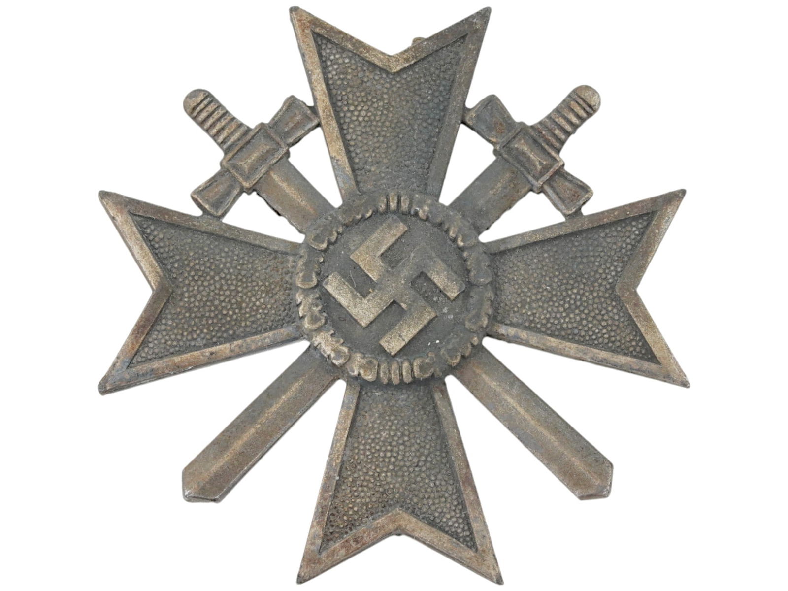 WWII NAZI GERMAN WAR MERIT CROSS MEDAL 1ST CLASS: A WWII Nazi German War Merit Cross medal. Features the form of a Maltese cross with a circular centerpiece with an embossed, canted swastika encircled by a detailed oak leaf wreath on two crossed swor