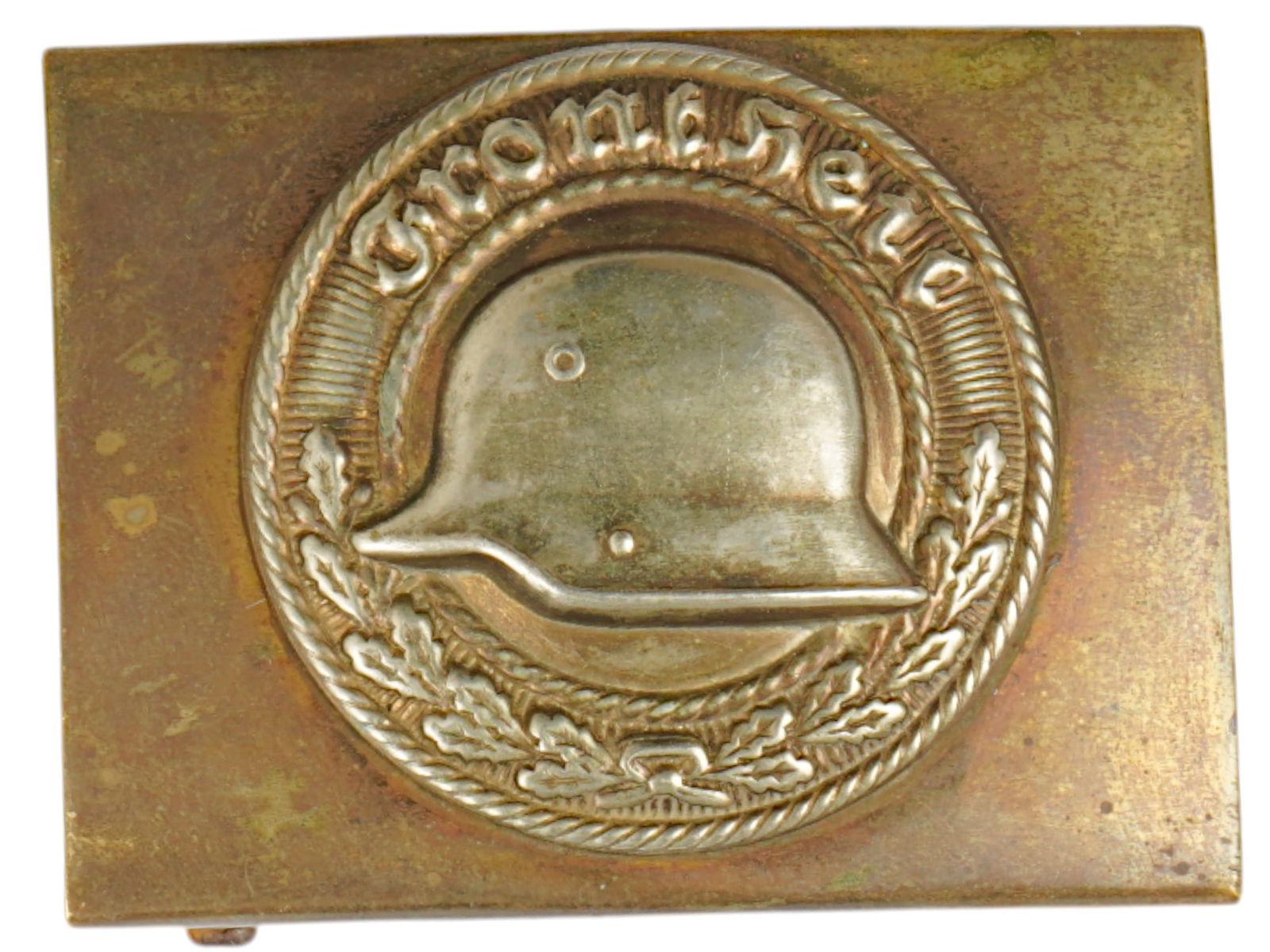 WWII NAZI GERMAN STAHLHELM BELT BUCKLE F VETERANS: A WWII Nazi German Stahlhelm belt buckle for veterans. The front is embossed with a round oak leaf wreath and inscription, Front Heil, encompassing a slightly domed inner field with a steel helmet. Se