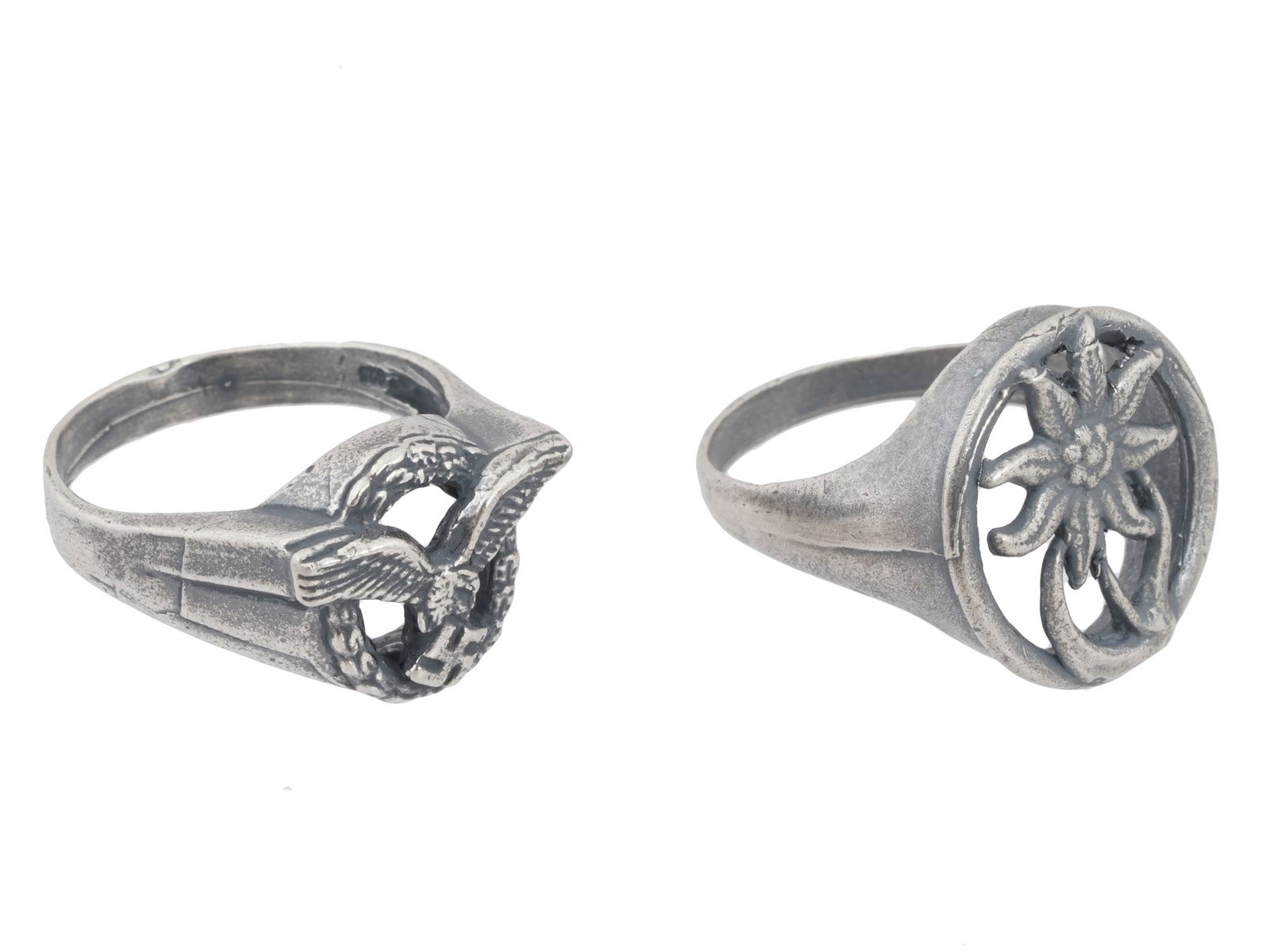 LOT OF TWO WWII MODEL NAZI GERMAN SILVER RINGS: A lot of two WWII model Nazi German Third Reich Silver rings. The first: a Luftwaffe pilots silver ring featuring a Luftwaffe emblem with a Nazi eagle holding a swastika insignia. The second: an Edelw