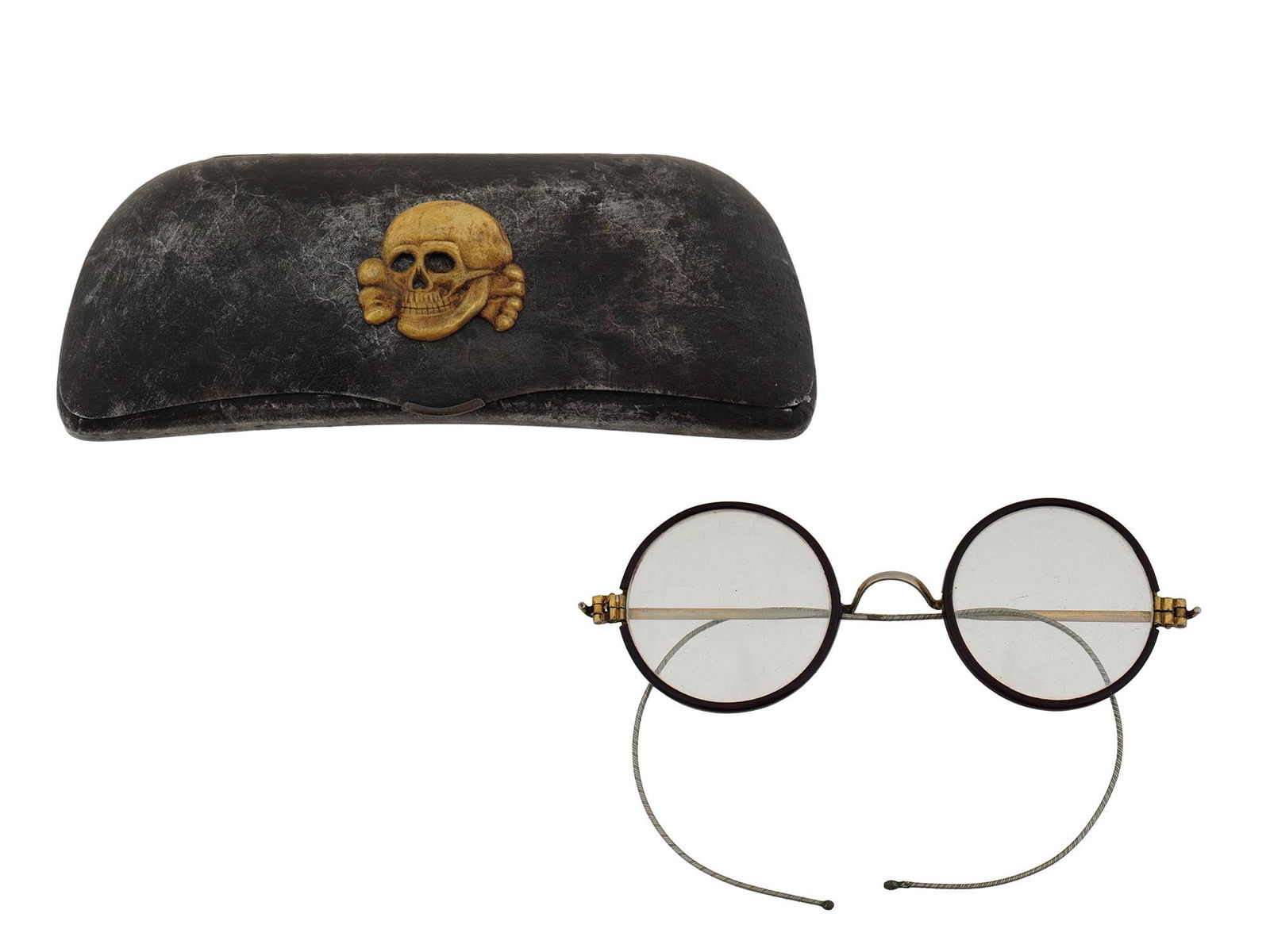 GERMAN WWII SS TOTENKOPF EYEGLASSES WITH CASE: A pair of World War II type German eye glasses. Round shape, metal frame. The glasses come in a steel case decorated with gilt SS Totenkopf overlay. Lined with velvet inside. Second World War Historic