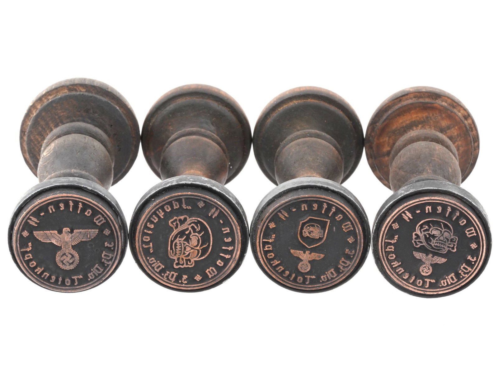 GROUP OF FOUR WORLD WAR II NAZI GERMAN WAFFEN SS STAMPS: A group of four WWII Nazi German Waffen SS wooden hand stamps, all originating from the Waffen SS Division Totenkopf. Second World War Nazi German Hand Stamps For Collectors. Dimensions: H 4 1/2 in. D
