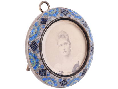 RUSSIAN IMPERIAL SILVER ENAMEL TABLE PICTURE FRAME: A Russian silver round table frame featuring cloisonne enamel decorations to the front, with a wooden back panel, easel stand and hanging loop. Shows a portrait of Alexandra Feodorovna, 1872 to 1918,