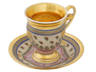 RUSSIAN PORCELAIN TEACUP AND SAUCER WITH GILT DESIGN