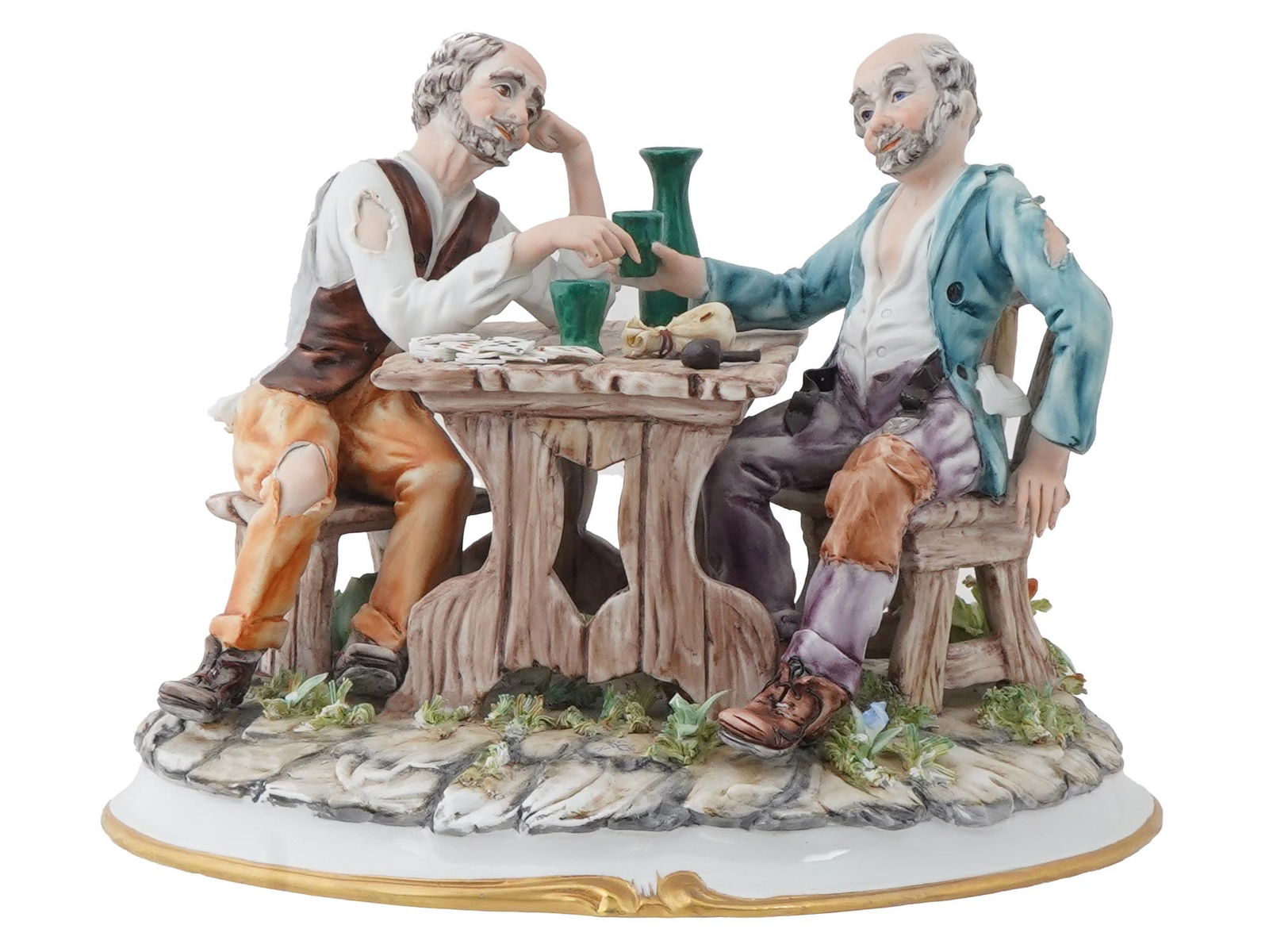 VINTAGE ITALIAN CAPODIMONTE PORCELAIN FIGURINE: A vintage Italian Capodimonte hand painted polychrome porcelain figurine. Circa mid to late 20th century. The figurine represents a sculpted composition with men playing cards and drinking. Marked and