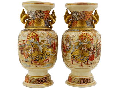PAIR OF JAPANESE SATSUMA GILDED PORCELAIN VASES: A pair of Japanese Satsuma porcelain vases. Each of circular base, with large curved bodies, and trumpet shaped flared rims. Both vases have identical polychrome Royal courtyard scenes with images of