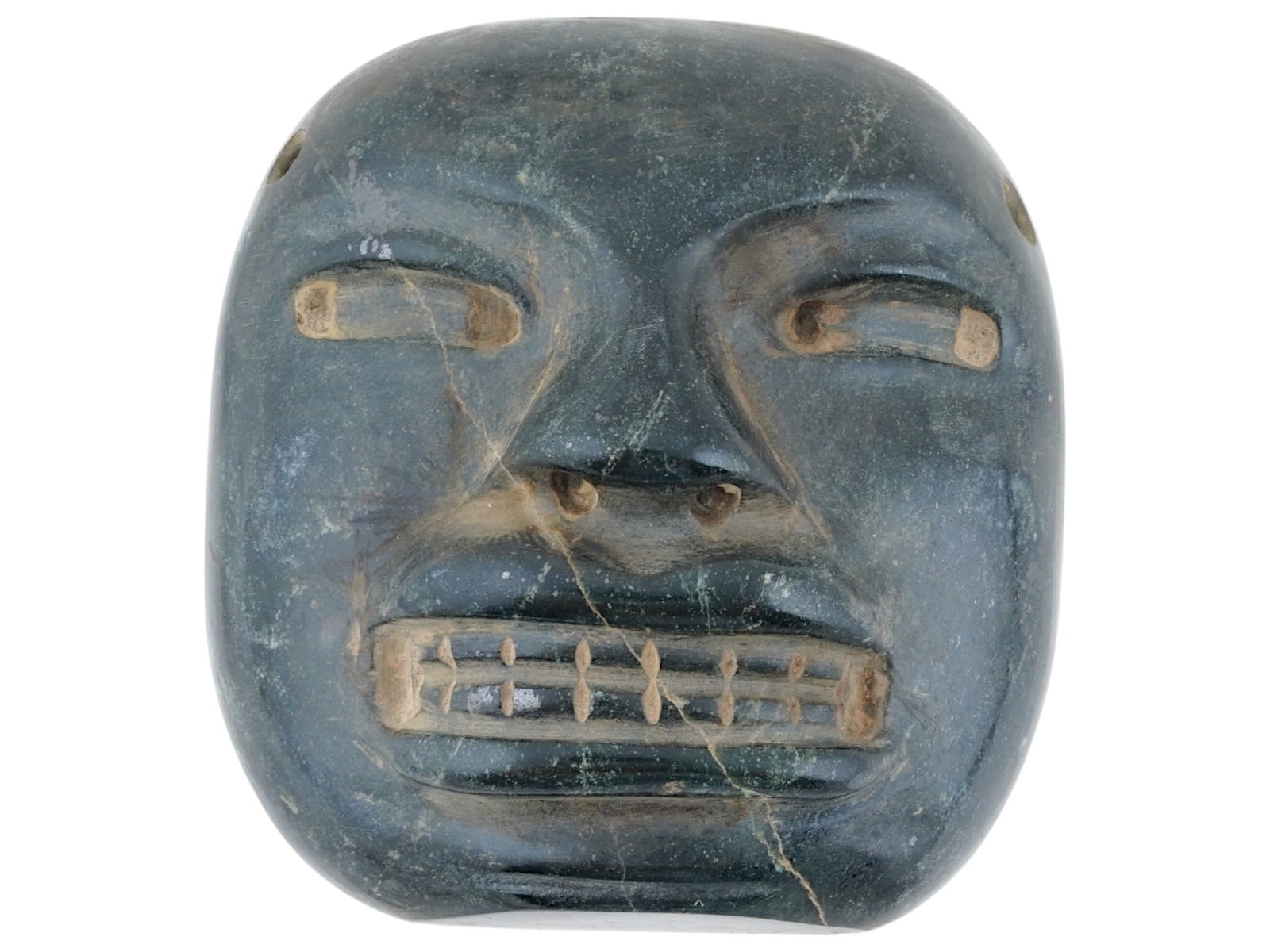ANCIENT PRE COLUMBIAN OLMEC STONE MASK 1150 TO 550 BC: An ancient Pre Columbian Olmec stone mask, ca. 1150 to 550 BC. It displays stylized human features. The eyes are narrow and rectangular, and the mouth is open, with a row of teeth. The face has a roun