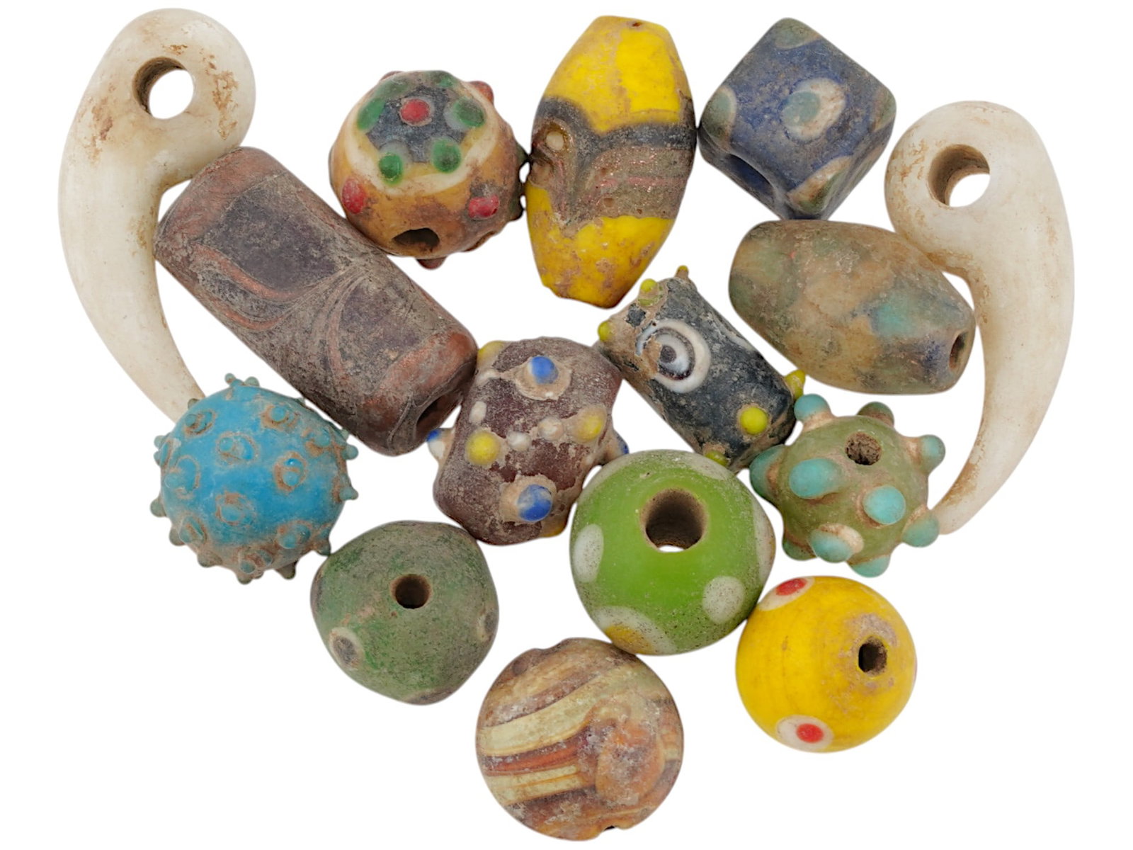15 ANCIENT PHOENICIAN GLASS BEADS 500 TO 300 BC: A collection of 15 Phoenician glass beads, dating from 500 to 300 BC. The beads exhibit a variety of shapes, colors, and patterns, including spherical, cylindrical, and geometric forms, with intricate