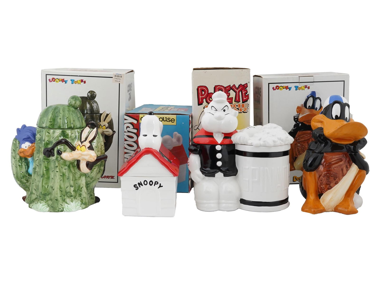 COLLECTION OF AMERICAN CARTOON PORCELAIN COOKIE JARS: A collection of four American porcelain cookie jars. The jars are decorated with characters from the cartoon series, Snoopy, Looney Tunes, and Popeye. Each is presented in an original box. Marked, Ben