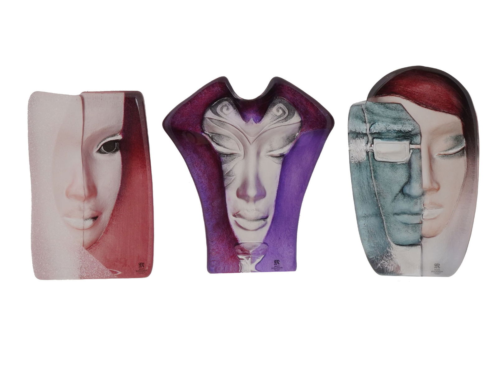 MATS JONASSON SWEDISH CRYSTAL ARTWORKS: A lot of three lead crystal decorative pieces or paperweights by Mats Jonasson, born 1945, a Swedish glass designer. Manufactured by the glassworks in Maleras, Sweden. MASQ series. Batzeba. FeMale. Mo