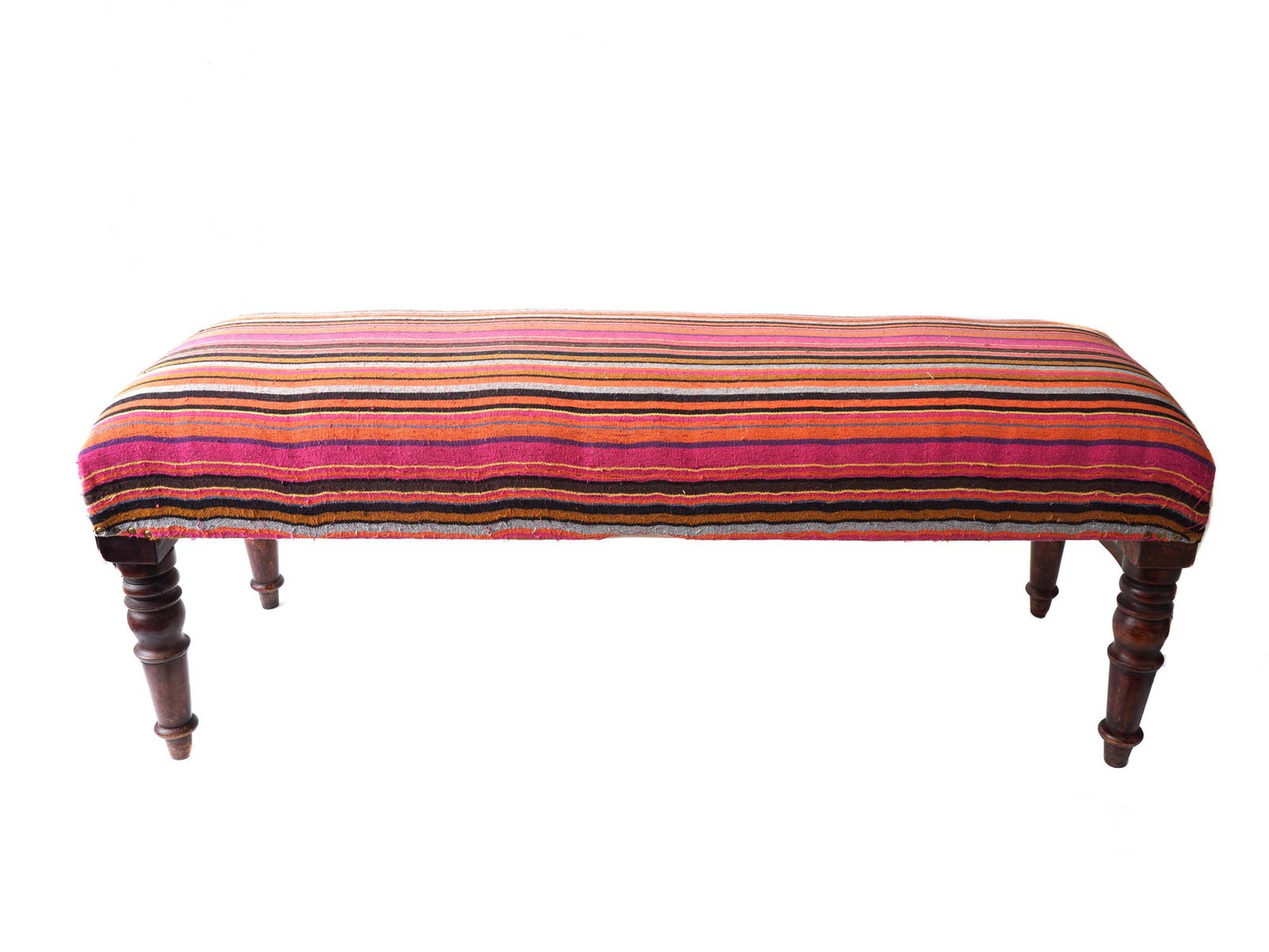 VINTAGE WOODEN ELONGATED BANQUETTE BENCH: A vintage wooden elongated banquette bench with four figured legs tapering downwards. The upper part is raised and covered with striped fabric in a warm color scheme. Antique And Vintage Furniture, Ch