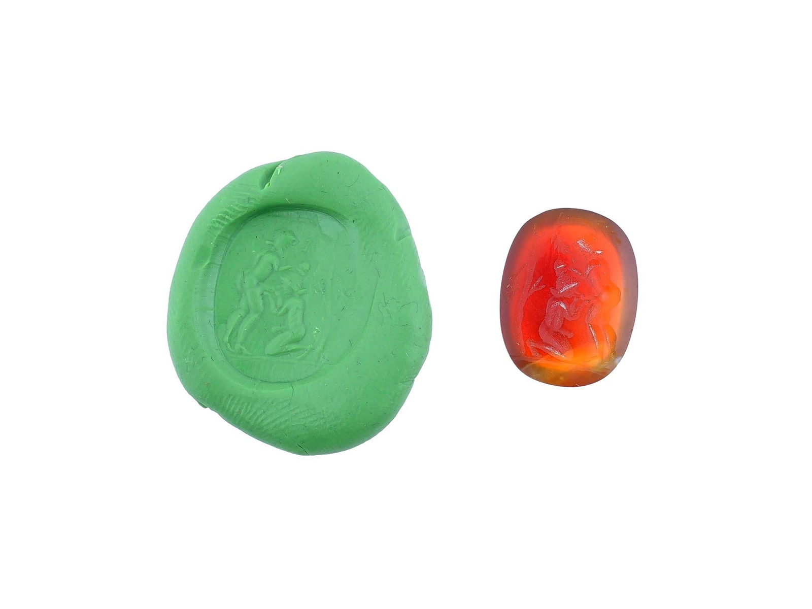 CARVED STONE INTAGLIO ANCIENT ROMAN EROTIC SCENE: A carved carnelian stone intaglio featuring an ancient Roman erotic scene involving two human figures. This detailed engraving reflects the artistic and symbolic traditions of antiquity, where such im