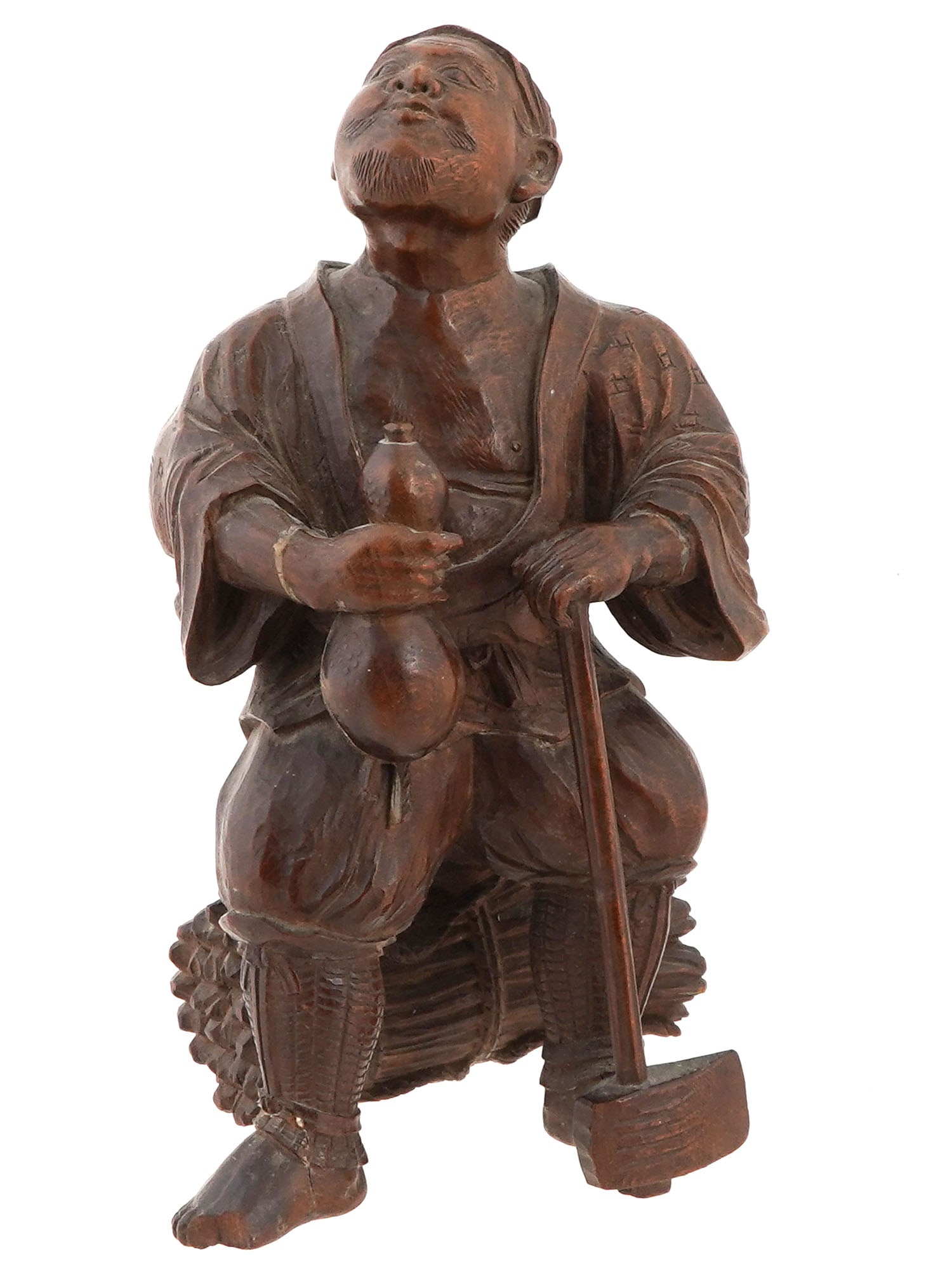 ANTIQUE JAPANESE MEIJI CARVED WOODEN SCULPTURE: An antique Japanese hand-caarved wooden figurine representing a man with a bundle of brushwood. Meiji period, 1868 to 1912. Signed on the bottom. Collectible Oriental Asian Carvings And Sculpture.THIS