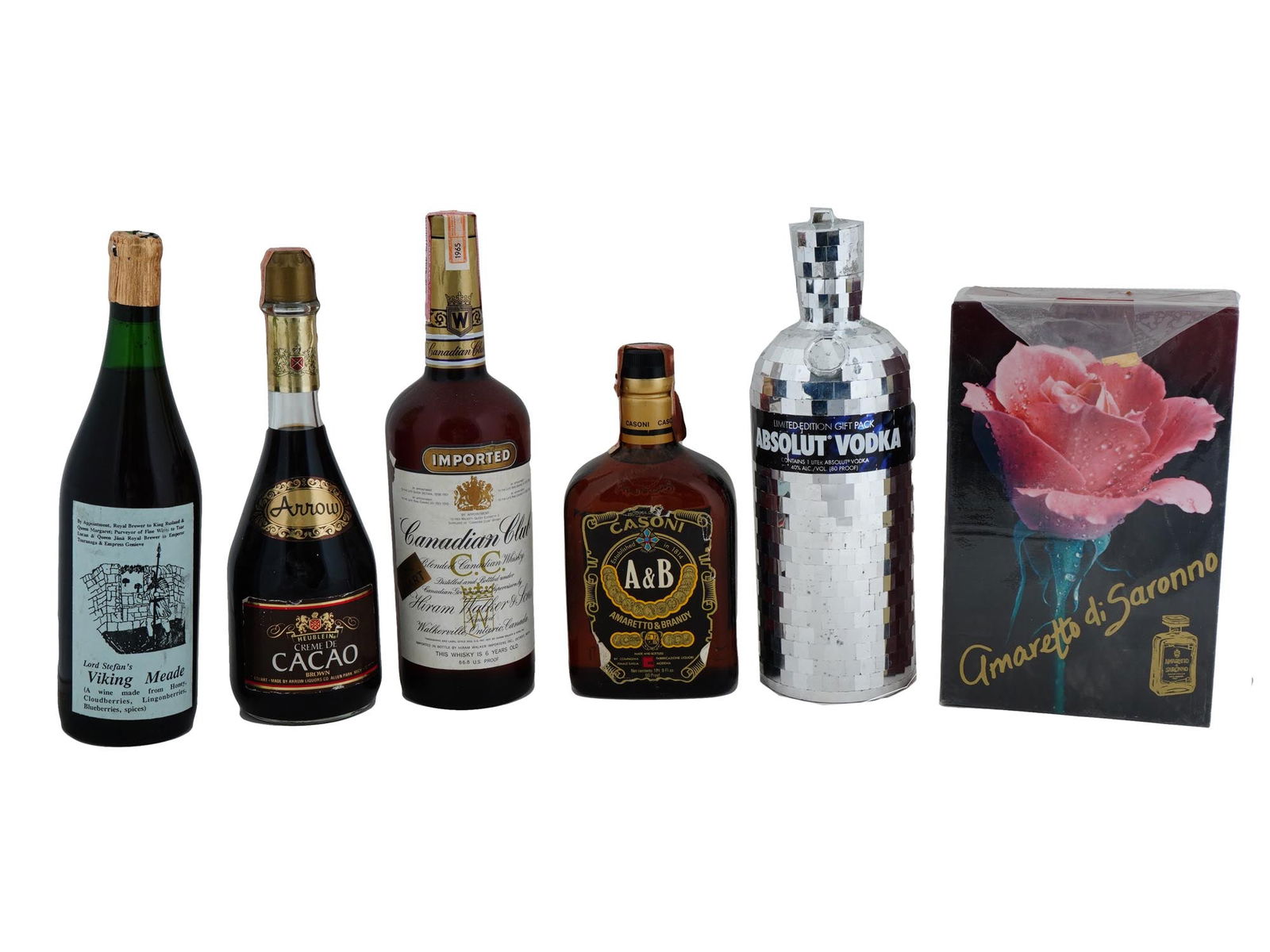 SEALED ALCOHOL BOTTLES WHISKEY COGNAC LIQUEUR WINE: A lot of vintage sealed alcohol bottles. A total of 6 items. The lot includes AB Amaretto and Brandy Cognac, Lord Stefans Viking Mead wine, Arrow Heublein Creme De Cacao liqueur, Canadian Club Whiskey