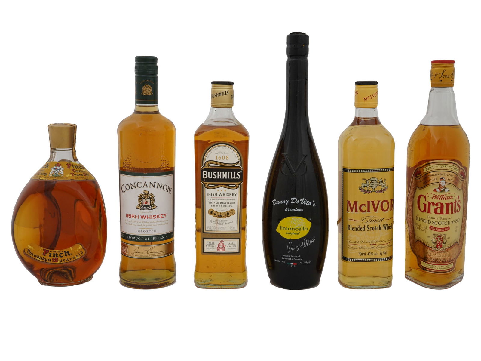 VINTAGE SEALED ALCOHOL BOTTLES WHISKEY LIMONCELLO: A lot of vintage sealed alcohol bottles, mostly whiskey. A total of 6 items. Pinch 12 year old blended Scotch whisky. Concanon Irish Whiskey. Bushmills Irish Whiskey. Danny DeVito Limoncello. Mcivor b