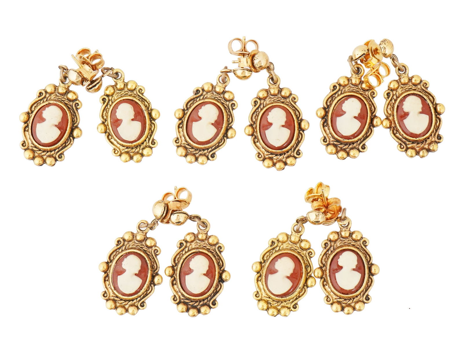 VINTAGE FEMALE PORTRAIT CAMEO STUD EARRINGS: A lot of 5 pairs of identical vintage gold-tone metal stud earrings. Danling cameos representing a female profile. Unmarked. Statement Costume Jewelry For Women.THIS LOT QUALIFIES FOR A 30-DAY UNCONDI