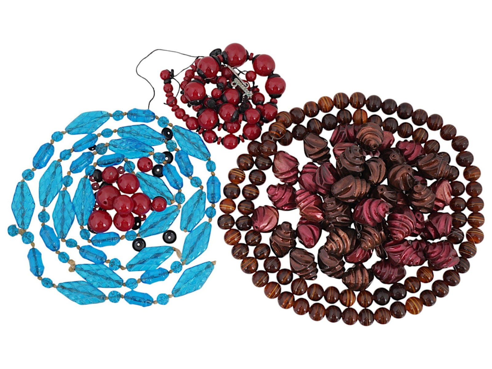 COLLECTION OF CARVED STONE BEADS IN VARIOUS COLORS: A collection of mixed carved stone beads in various colors, featuring ball-shaped, elongated, and other unique forms. Some of the beads are strung on a temporary string, making them ideal for custom j