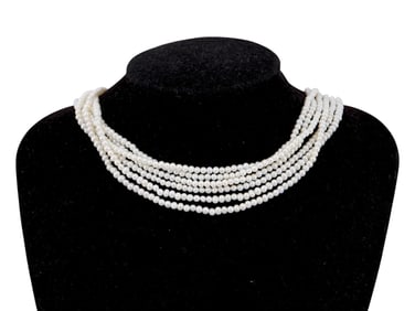 SEVERAL STRINGS OF ROUNDED CREAMY WHITE PEARL BEADS