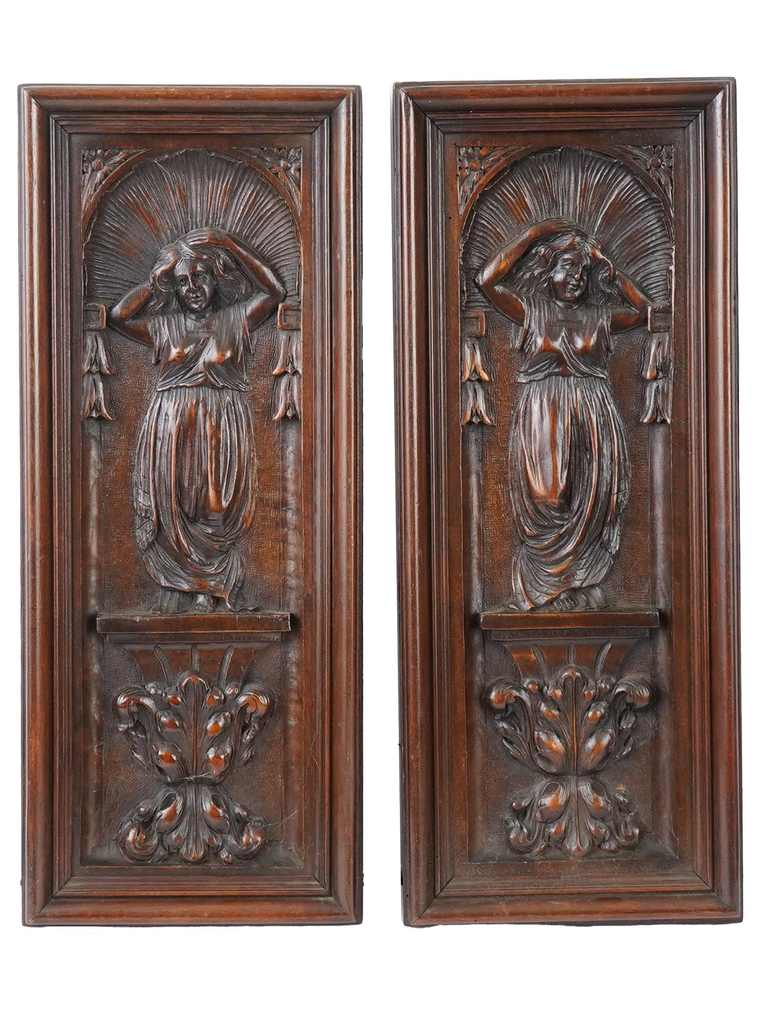 EUROPEAN CONTINENTAL HAND CARVED OAK WOOD PANELS: A pair of European Continental hand carved oak wood panels. The panels are elongated rectangular in shape with an almost identical image of a female figure in flowing clothing at the top and plant dec