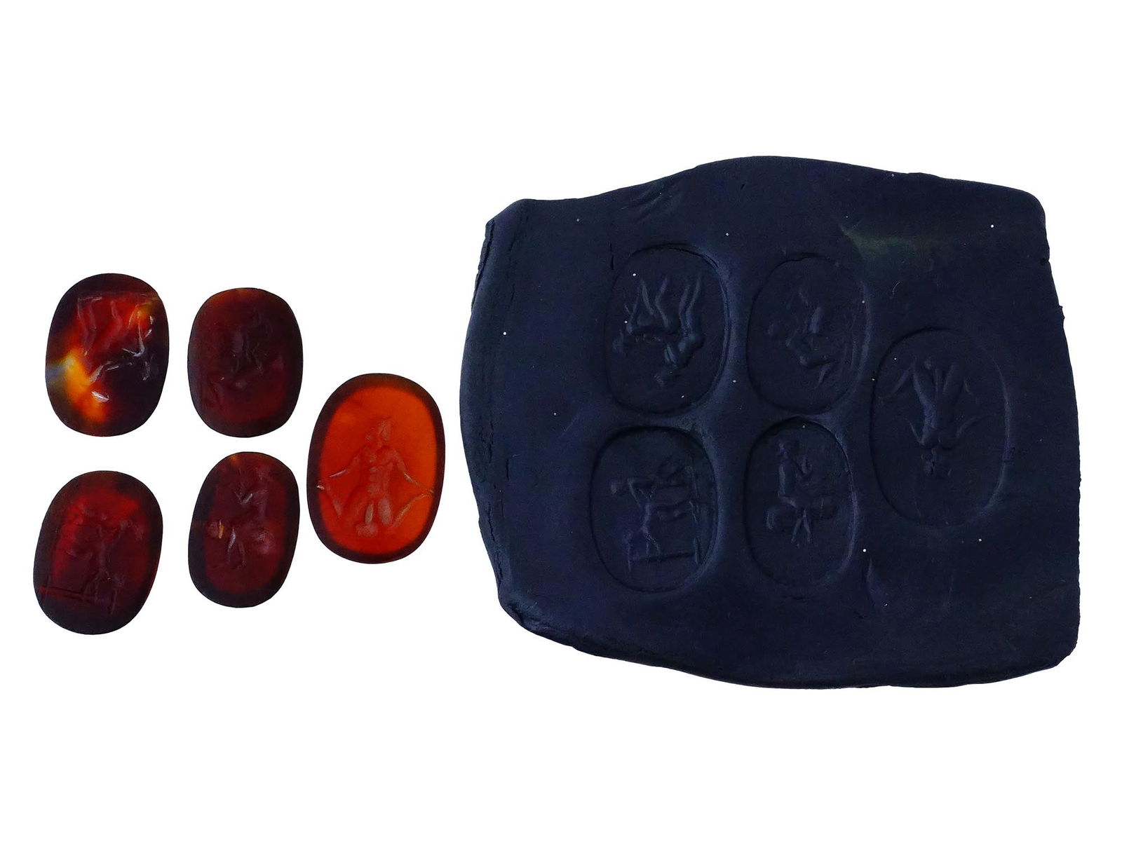LOT OF ANCIENT MANNER EROTIC STONE INTAGLIO SEALS: A lot of five hand carved probably carnelian stone intaglio seals featuring ancient Roman erotic scenes. Such pieces were often used as personal seals, amulets, or jewelry, where such imagery was some