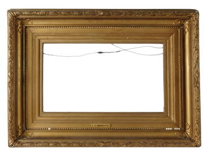 ANTIQUE GILT WOOD PICTURE FRAME W KENSETT PLAQUE: An antique gilt wood carved picture frame with lush foliate decor. Circa mid to late 19th century. Lower in the center is a metal plaque with the name J. F. Kensett, which probably refers to the Ameri