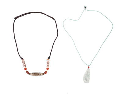 LOT OF ASIAN JADE PENDANT AND DZI BEADS NECKLACES: A lot of two Asian necklaces. The lot includes a necklace featuring a Chinese carved Jade amulet pendant; and a probably Tibetan necklace decorated with Dzi beads with dragon veins and eyed ornaments