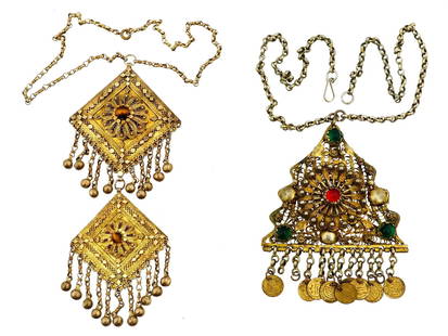 ANTIQUE YEMENI GILT SILVER GEMSTONE PENDANTS: A pair of antique late 19th-century Middle Eastern pendants. Yemeni origin. Gilt silver filigree pieces of triangular and square shape. Set with tigers eye, emerald, and ruby cabochons. Adorned with d