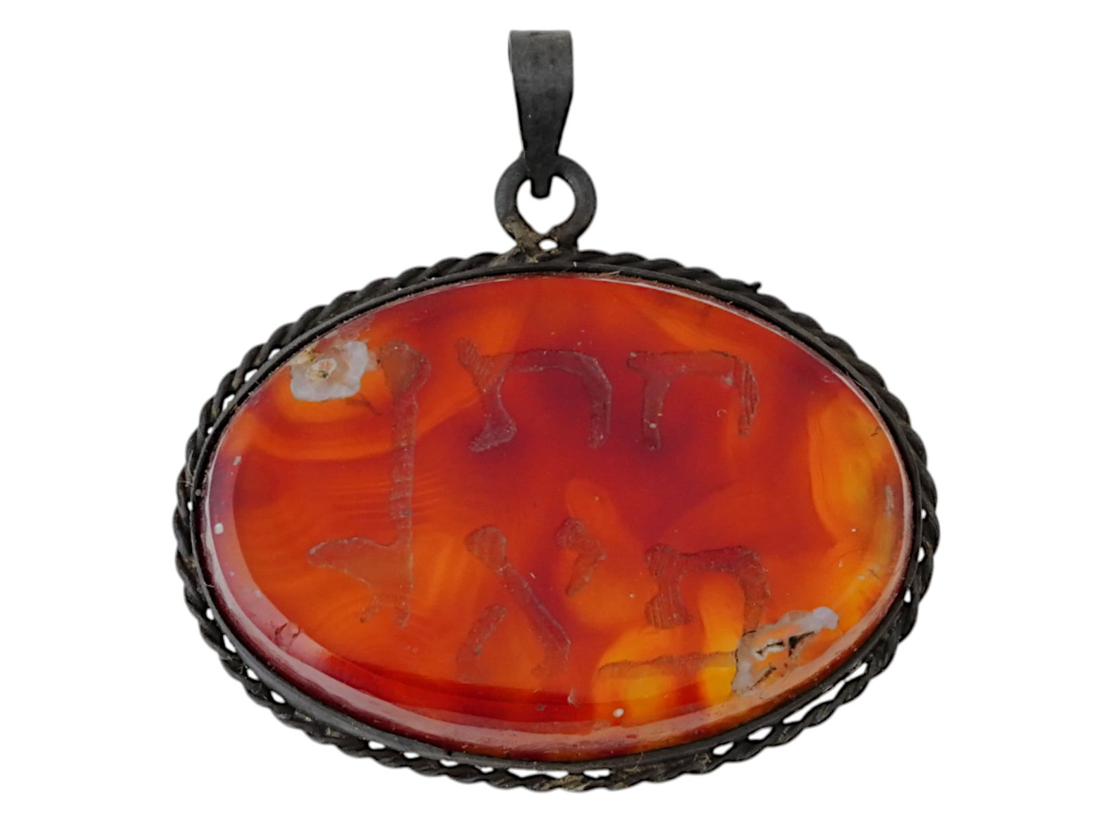 ANTIQUE HOLY LAND BIBLICAL PROTECTION AMULET PENDANT: An antique Holy Land biblical protection amulet pendant crafted from carnelian, featuring finely engraved Hebrew inscriptions believed to offer spiritual safeguarding. The amulet is mounted with silve