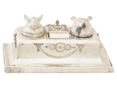 RUSSIAN SILVER DOUBLE INKWELL WITH STAMP COMPARTMENT: A Russian silver double inkwell with a stamp compartment. The inkwell is designed in a rectangular shape with two inkwell containers topped with animal heads: a boar and a bear. Between the inkwells i